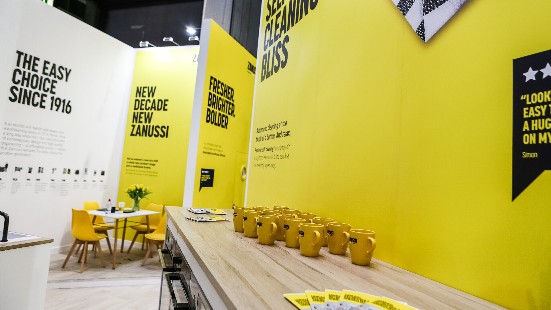 branded zanussi mugs on a side next to a seating area