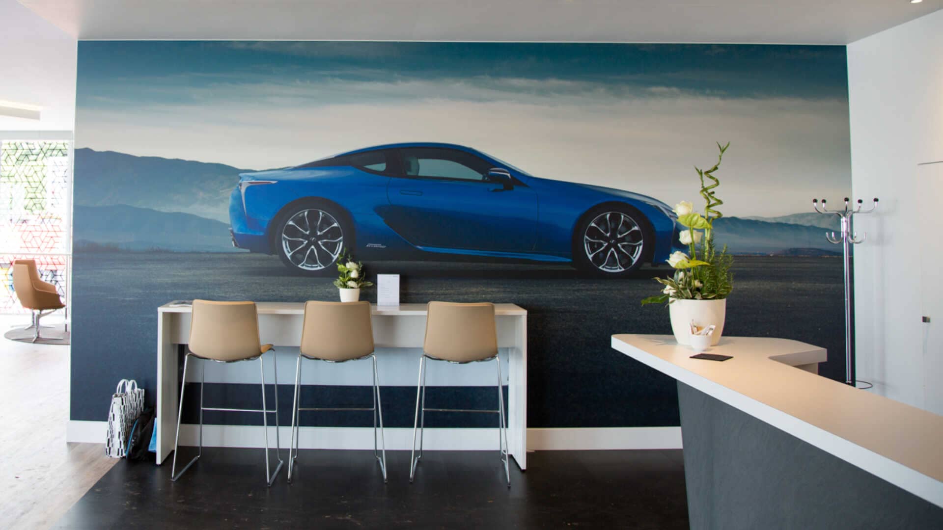 car feature wall behind a seating area and a desk