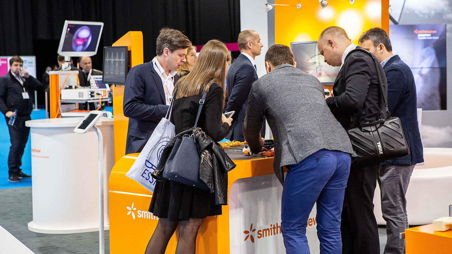 people engaging with smith and nephew event stand