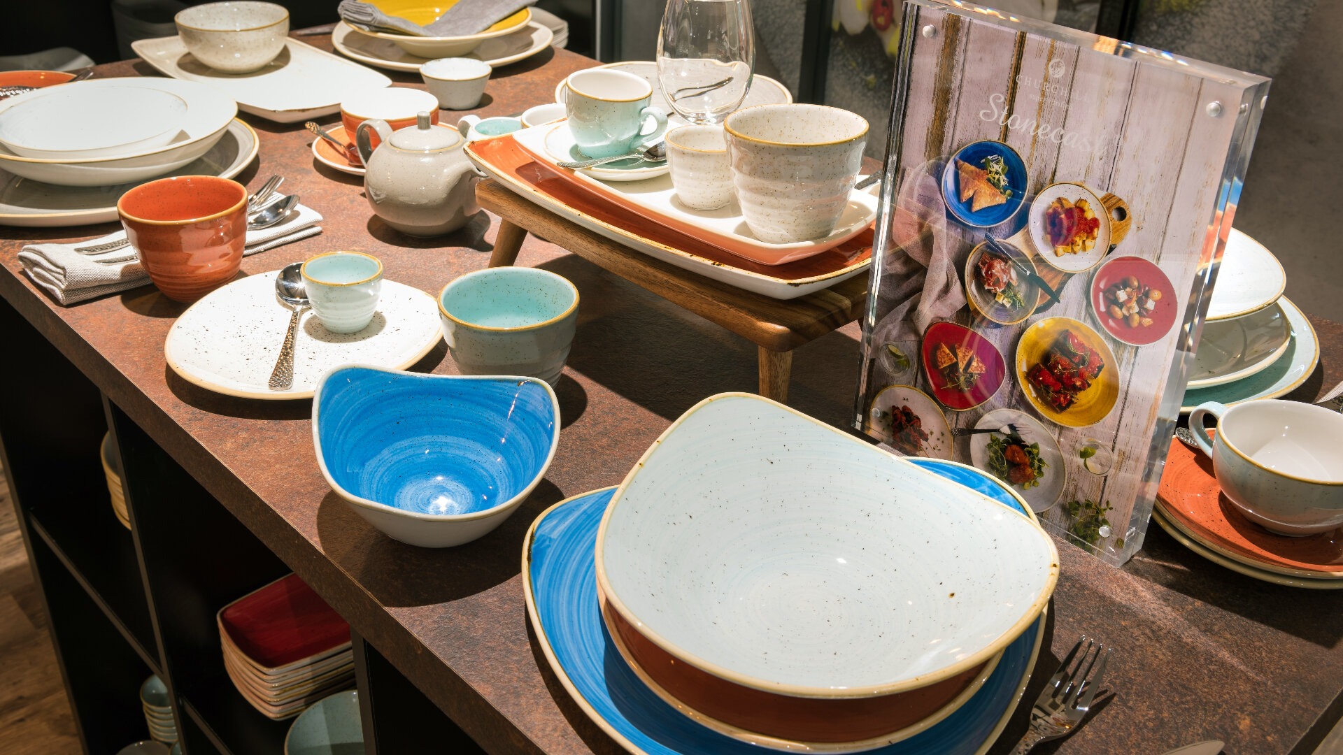 stonecast plates glasses and bowls displayed on a table