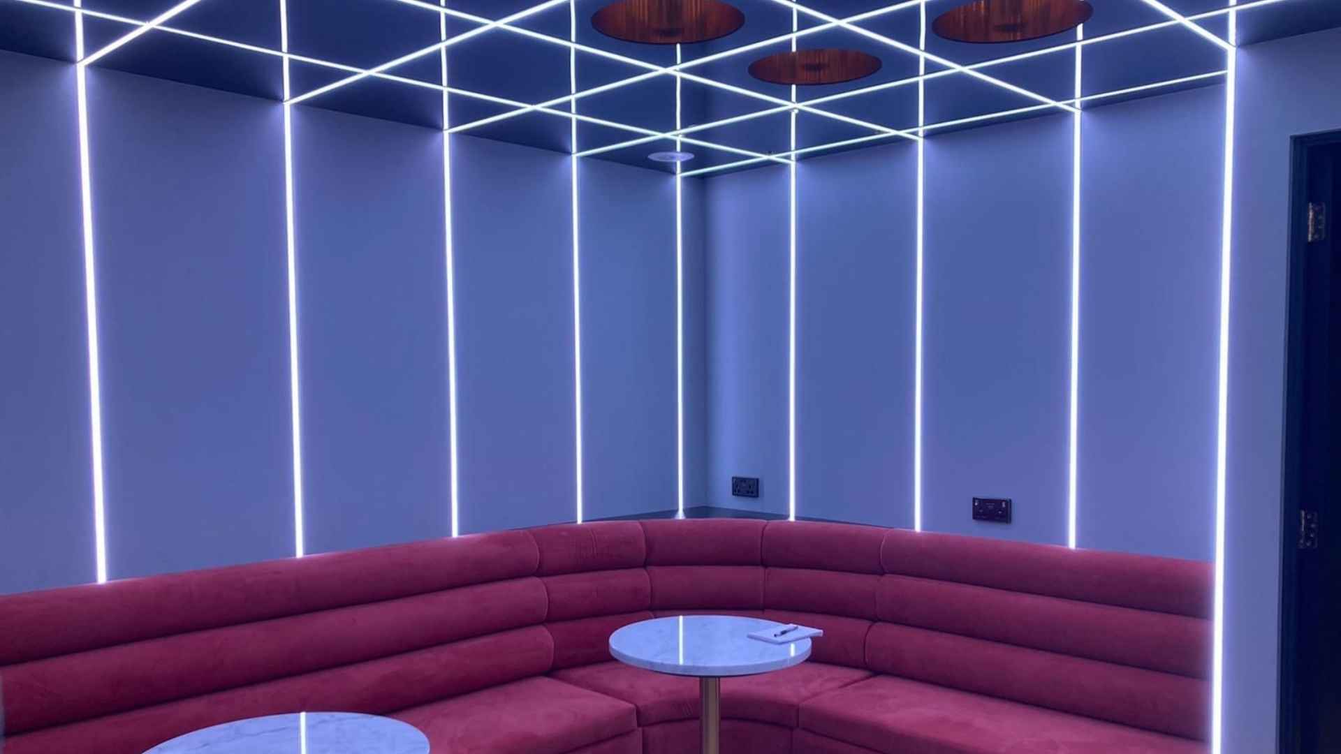 the cube bespoke lighting and seating area inside the ao arena's executive suite
